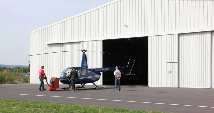 White Aircraft Hangar with large doors built fast with steel structure.